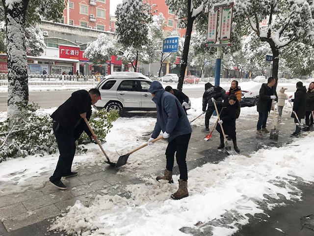 1鹤城区民政局志愿者在人行道清扫冰雪.jpg
